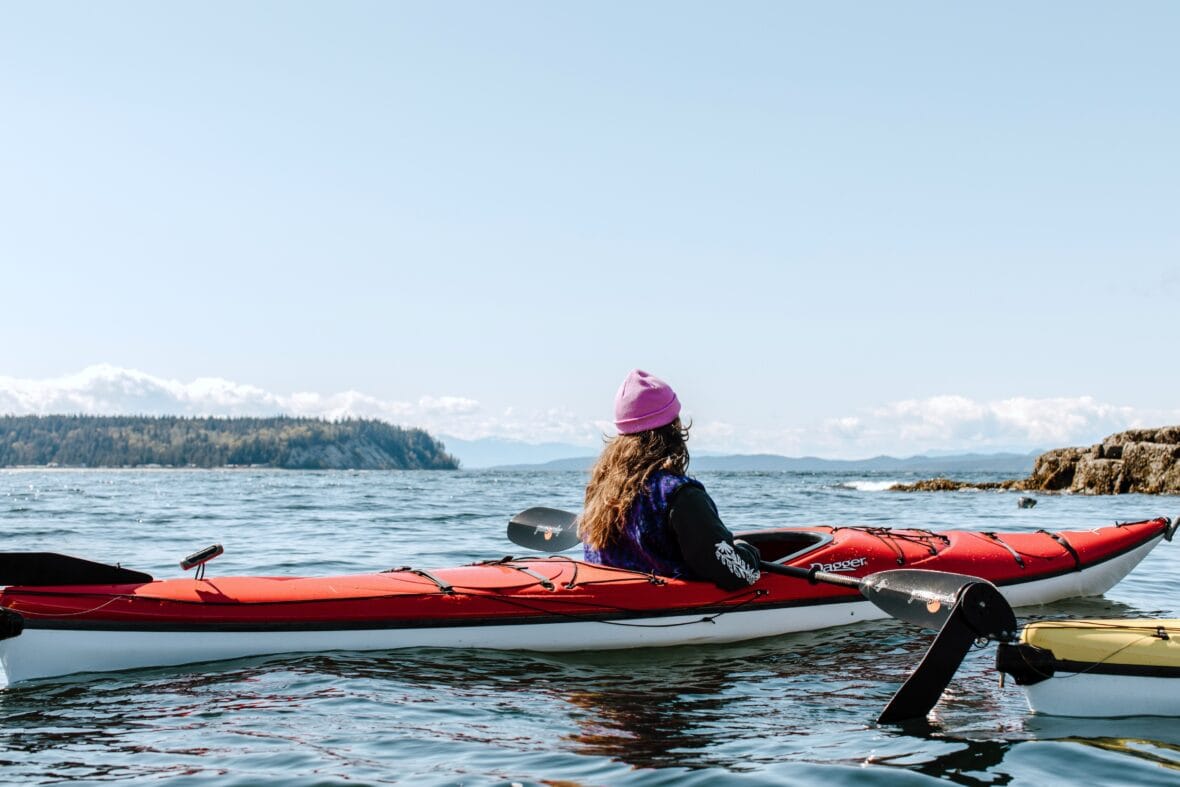 A person kayaking in Secret Cove in Halfmoon Bay on the Sunshine Coast