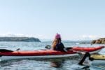 A person kayaking in Secret Cove in Halfmoon Bay on the Sunshine Coast